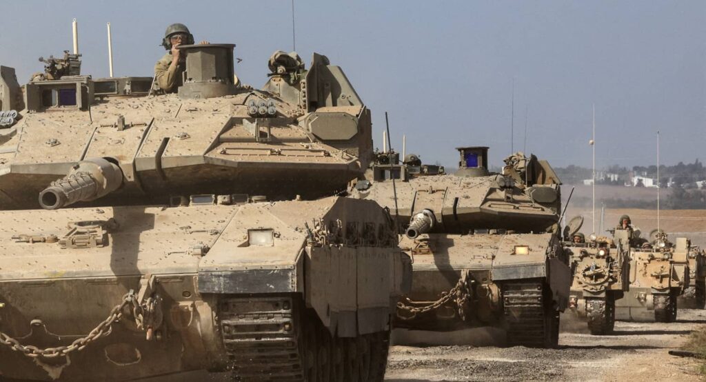 Israeli tanks and military vehicles take position near Israel's border with the Gaza Strip, October 13, 2023. Photo credit: REUTERS/Violeta Santos Moura