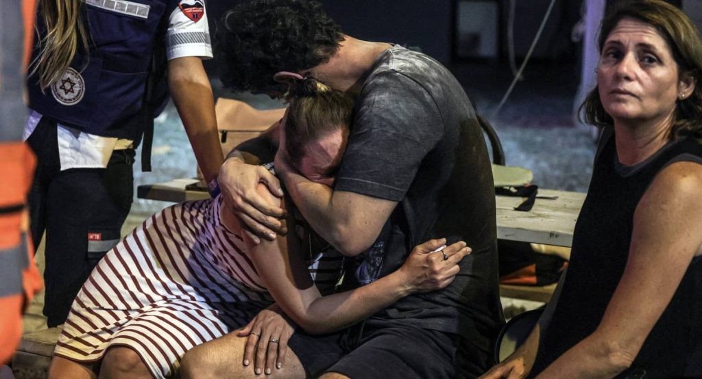 People at the site where a rocket launched from Gaza landed in Tel Aviv, October 7, 2023. Photo credit: REUTERS/Itai Ron