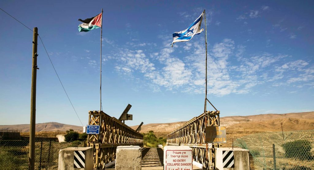 Jordanian and Israeli flags as seen on the Naharayim bridge on the border between Israel and Jordan. Photo credit: REUTERS/Baz Ratner