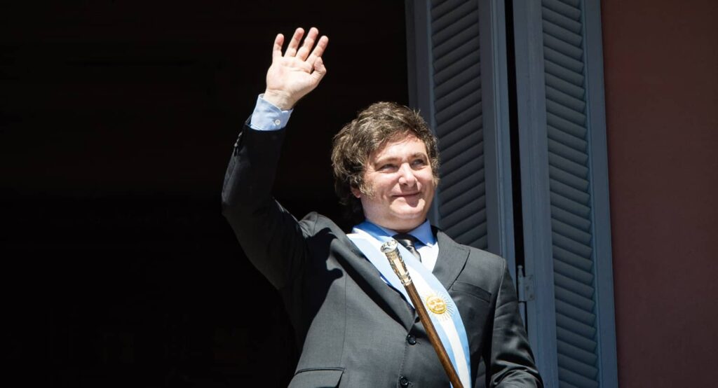 Javier Milei waves to his supporters from a balcony of the government palace after taking office as president on December 10, 2023. Photo credit: Florencia Martin/dpa via Reuters Connect.