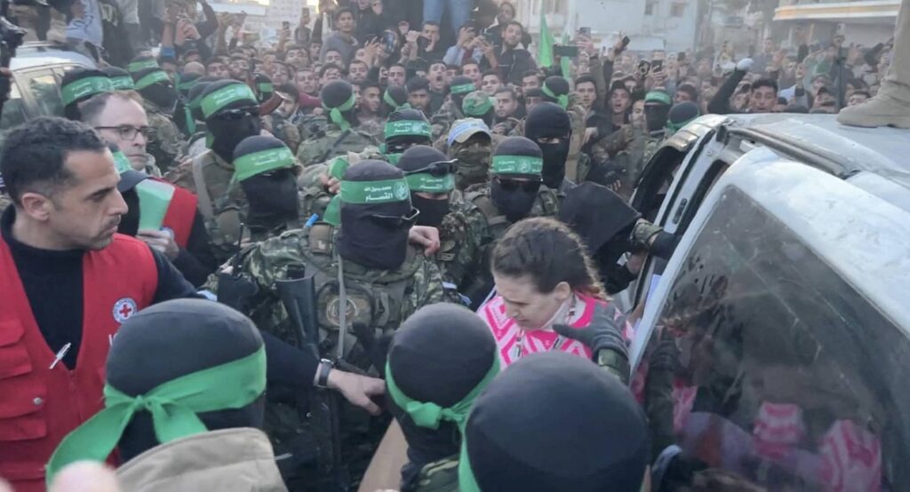 Hamas hands over Doron Steinbrecher, a hostage who had been held in Gaza since the October 7 2023 attack, to members of the Red Cross, January 19, 2025. Photo credit: REUTERS.